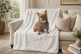 Load image into Gallery viewer, Charlie Bear plush blanket draped over a cream linen sofa in a bright living room
